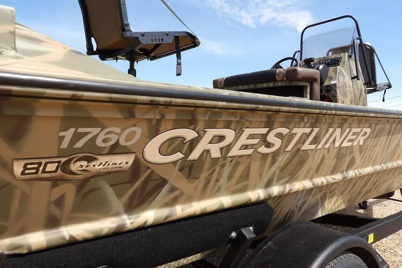 Slide: The Image of 2026 Crestliner 1760 Retriever FCC boat with camouflage design on trailer. - 38