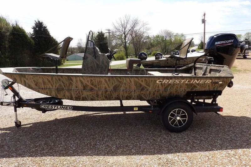 Slide: The Image of 2026 Crestliner 1760 Retriever FCC boat with camouflage design on a trailer. - 8