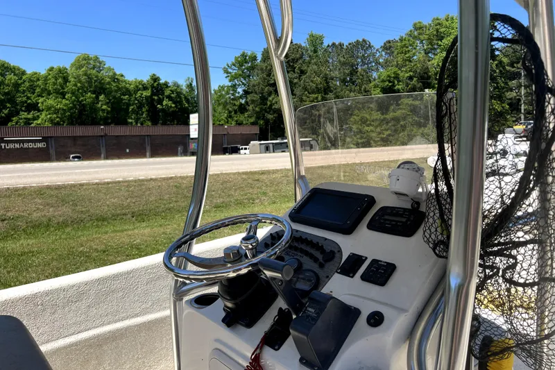 The Image of 2018 Carolina Skiff 258 DLV boat console with steering wheel and navigation equipment. - 1