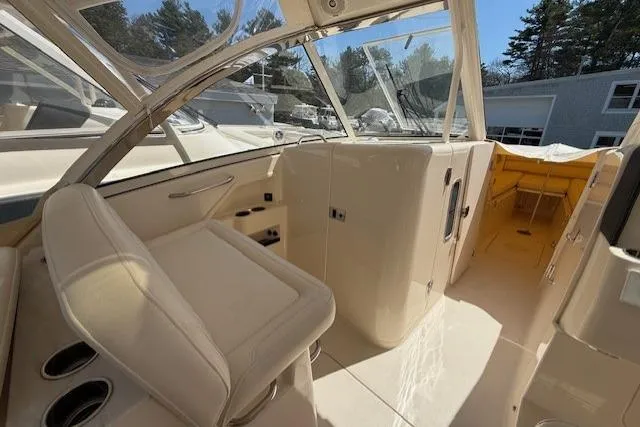 Slide: The Image of 2018 Grady-White Freedom 325 boat interior with seating and cabin view. - 11