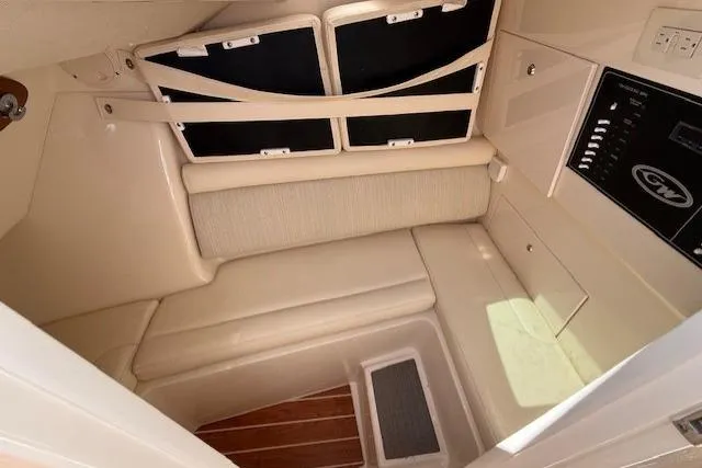 Slide: The Image of 2018 Grady-White Freedom 325 cabin interior with seating and control panel. - 14