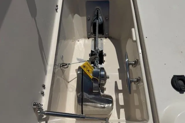 Slide: The Image of Anchor compartment of 2018 Grady-White Freedom 325 boat, featuring a stainless steel anchor winch. - 17