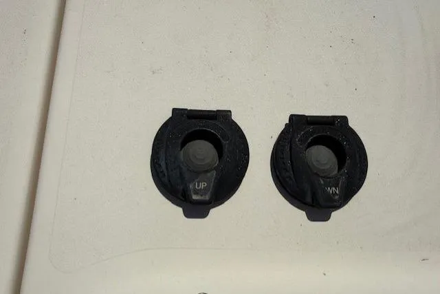 Slide: The Image of 2018 Grady-White Freedom 325 boat controls labeled "UP" and "DOWN" on a white surface. - 18