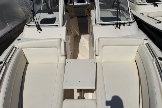 Slide: The Image of 2018 Grady-White Freedom 325 boat interior with white seating and table. - 19