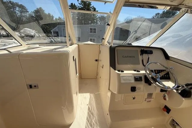 Slide: The Image of 2018 Grady-White Freedom 325 boat cockpit with Garmin navigation system and steering wheel. - 22