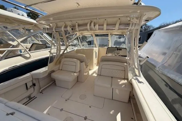 Slide: The Image of 2018 Grady-White Freedom 325 boat interior with seating and helm, showcasing spacious design. - 23
