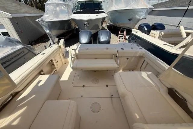 Slide: The Image of 2018 Grady-White Freedom 325 boat interior with seating and twin engines. - 25