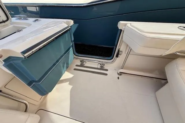 Slide: The Image of Interior view of a 2018 Grady-White Freedom 325 boat, featuring seating and storage. - 28