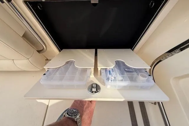 Slide: The Image of Storage compartment with tackle boxes on a 2018 Grady-White Freedom 325 boat. - 29