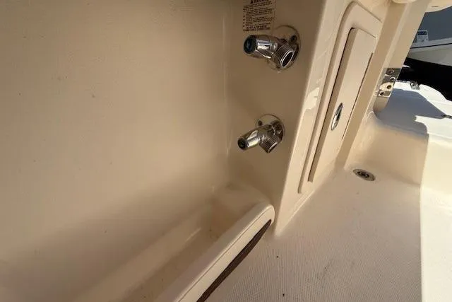 Slide: The Image of Grady-White Freedom 325 boat interior detail, showcasing faucet and storage compartment, 2018 model. - 30