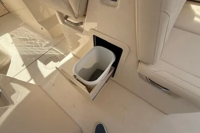 Slide: The Image of 2018 Grady-White Freedom 325 boat interior with built-in trash compartment. - 33