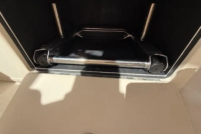 Slide: The Image of Storage compartment in a 2018 Grady-White Freedom 325 boat, featuring metal bars and shadow. - 35