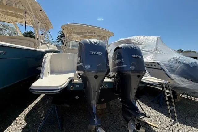 Slide: The Image of 2018 Grady-White Freedom 325 boat with twin Yamaha 300 engines, docked outdoors. - 4