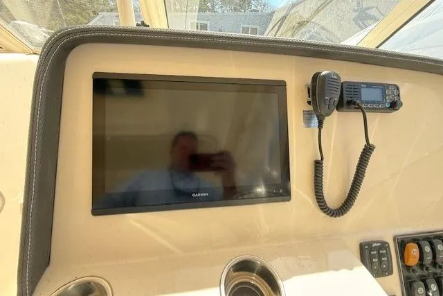 Slide: The Image of Dashboard of 2018 Grady-White Freedom 325 with Garmin display and communication device. - 40