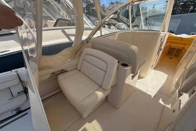 Slide: The Image of 2018 Grady-White Freedom 325 boat interior with beige seating and clear canopy. - 7