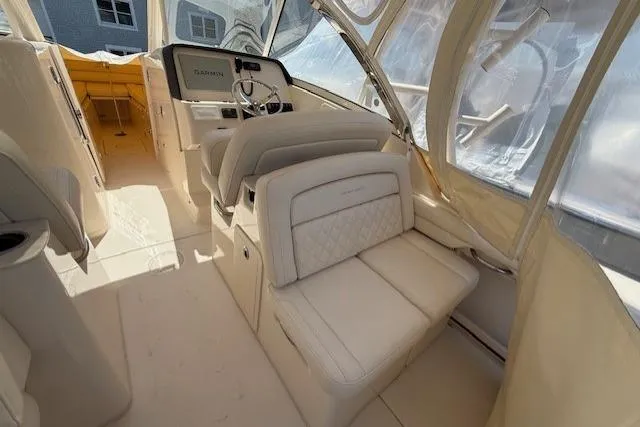 Slide: The Image of 2018 Grady-White Freedom 325 boat interior with helm and seating area. - 8