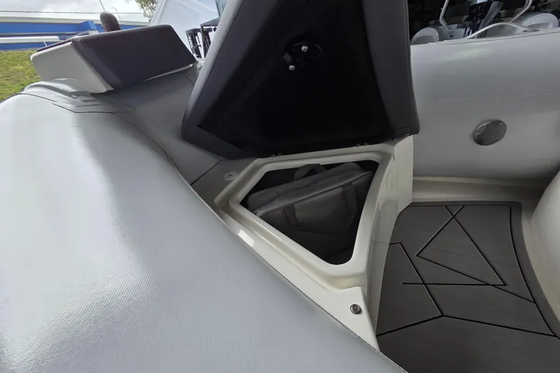 Slide: The Image of Open storage compartment in 2026 Northstar Vega 3.8 boat with Tohatsu 30HP engine. - 11