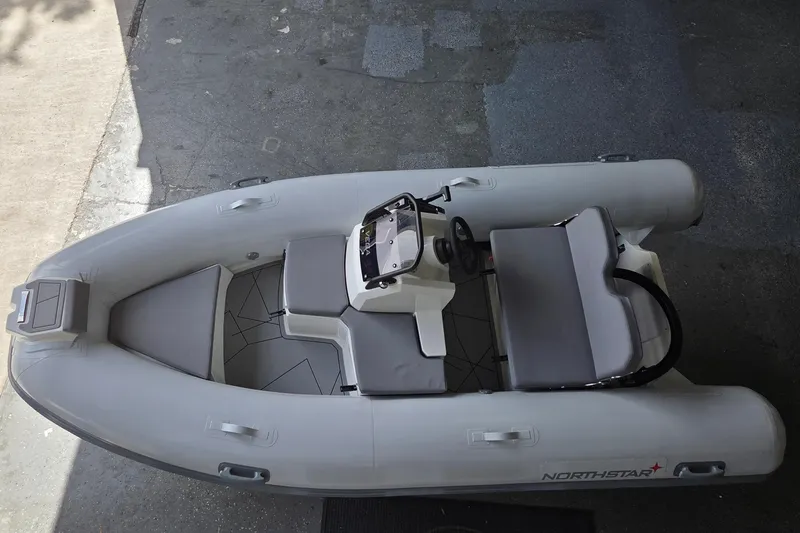 Slide: The Image of 2026 Northstar Vega 3.8 inflatable boat with Tohatsu 30HP engine, top view. - 3