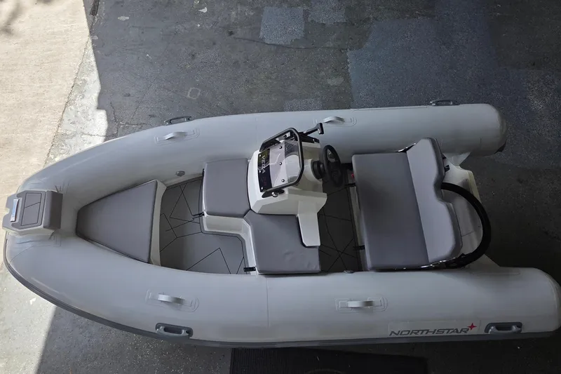 Slide: The Image of 2026 Northstar Vega 3.8 inflatable boat with Yamaha 25HP engine, top view. - 3