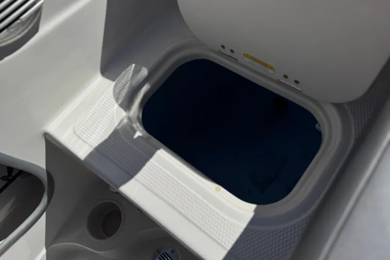 Slide: The Image of Open storage compartment on a 2016 Tahoe 550 TF boat. - 24