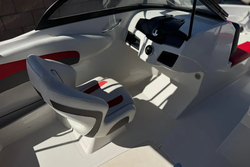 Slide: The Image of Interior of a 2016 Tahoe 550 TF boat featuring sleek white and red seating. - 27