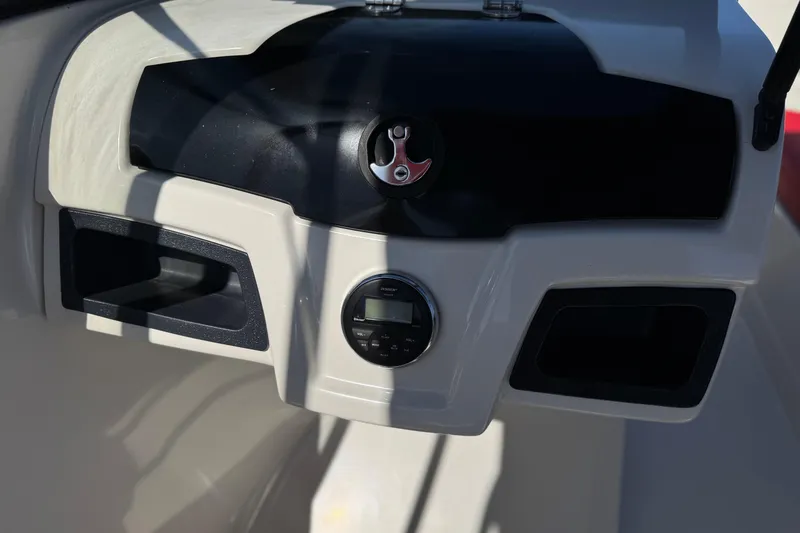 Slide: The Image of Dashboard of a 2016 Tahoe 550 TF boat with control panel and storage compartments. - 28
