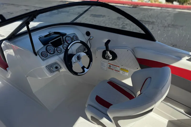 Slide: The Image of Cockpit of a 2016 Tahoe 550 TF boat with steering wheel and gauges. - 29