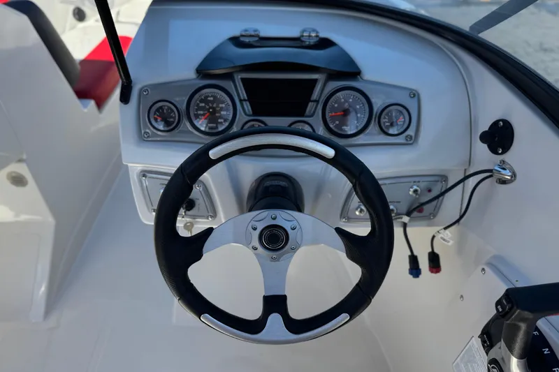 Slide: The Image of Steering console of a 2016 Tahoe 550 TF boat with gauges and controls. - 30