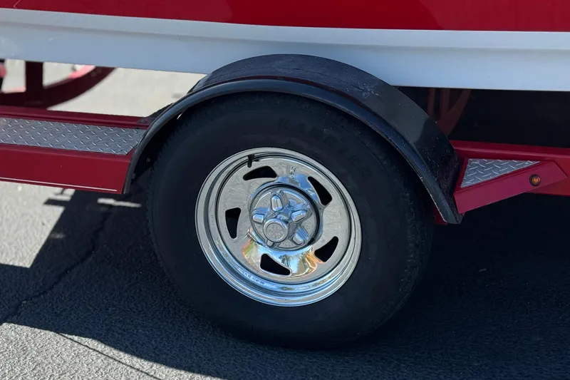 Slide: The Image of Close-up of a 2016 Tahoe 550 TF trailer wheel with chrome rim and red fender. - 31