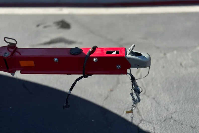 Slide: The Image of Red trailer hitch of a 2016 Tahoe 550 TF on asphalt background. - 32