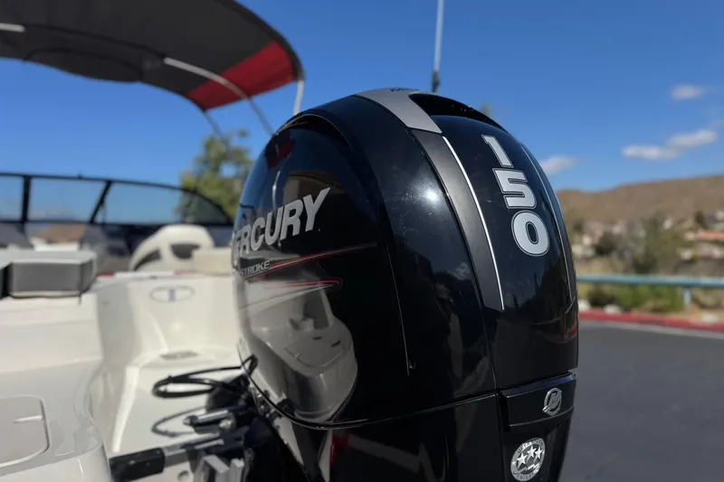 Slide: The Image of 2016 Tahoe 550 TF boat with Mercury 150 outboard motor, sunny day background. - 7