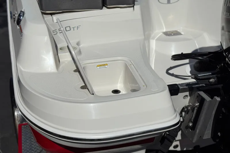Slide: The Image of 2016 Tahoe 550 TF boat stern with motor mount and storage compartment. - 8
