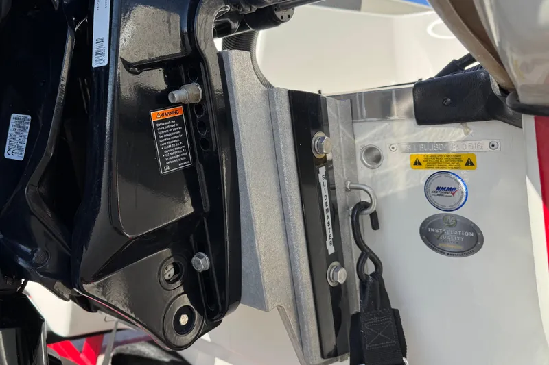 Slide: The Image of Close-up of 2016 Tahoe 550 TF boat engine mount with warning labels and installation quality badge. - 9