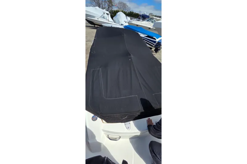 Slide: The Image of 2007 Sea Ray SLX 250 boat with black cover, parked outdoors. - 11