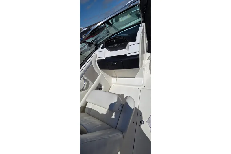 Slide: The Image of 2007 Sea Ray SLX 250 boat interior with steering wheel and seating. - 12