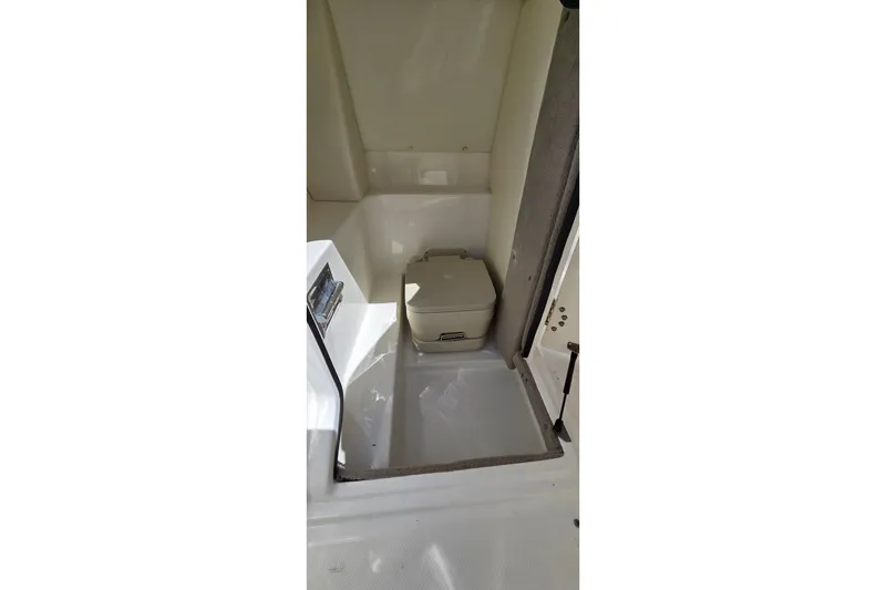 Slide: The Image of 2007 Sea Ray SLX 250 boat interior with compact toilet area. - 13