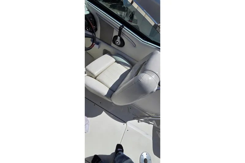 Slide: The Image of Interior of a 2007 Sea Ray SLX 250 boat, featuring a white captain's seat. - 14