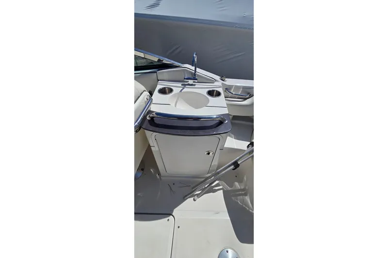 Slide: The Image of 2007 Sea Ray SLX 250 boat interior with sink and storage area. - 17