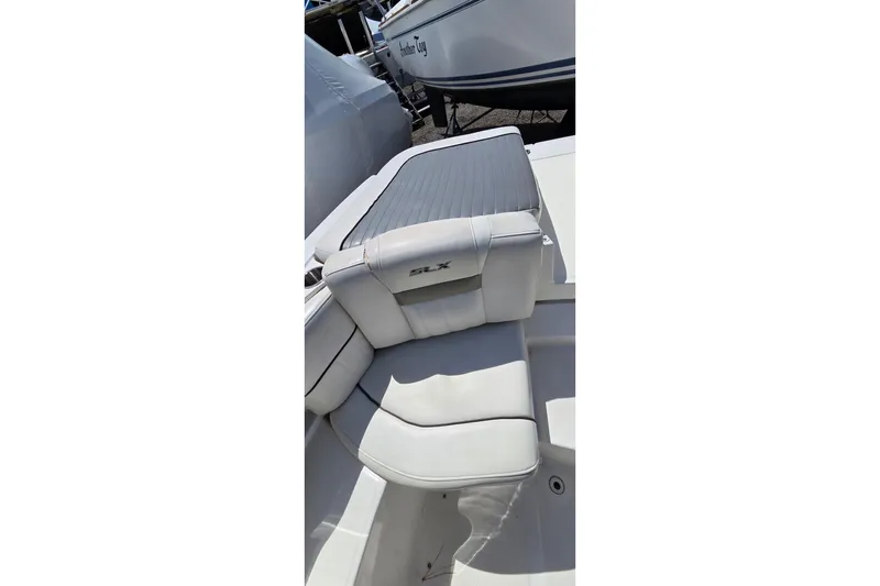 Slide: The Image of 2007 Sea Ray SLX 250 boat interior with white cushioned seating. - 19