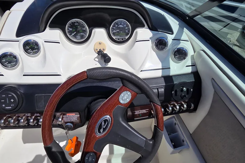 Slide: The Image of Steering wheel and dashboard of a 2007 Sea Ray SLX 250 boat. - 2