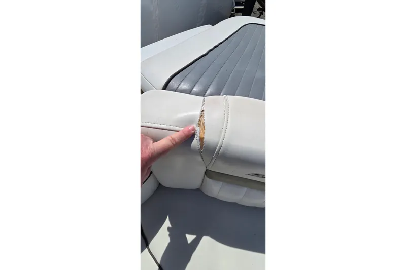Slide: The Image of Torn upholstery on 2007 Sea Ray SLX 250 boat seat, showing wear and damage. - 21