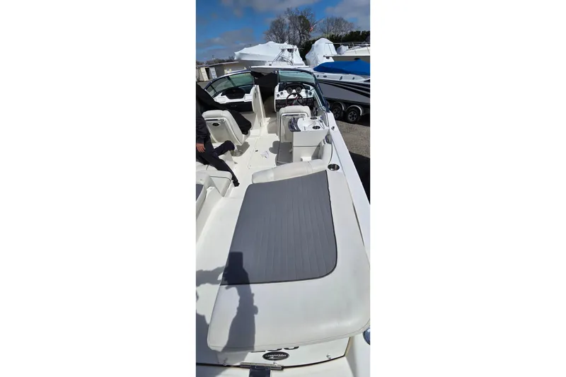 Slide: The Image of 2007 Sea Ray SLX 250 boat interior with seating and dashboard, docked outdoors. - 23