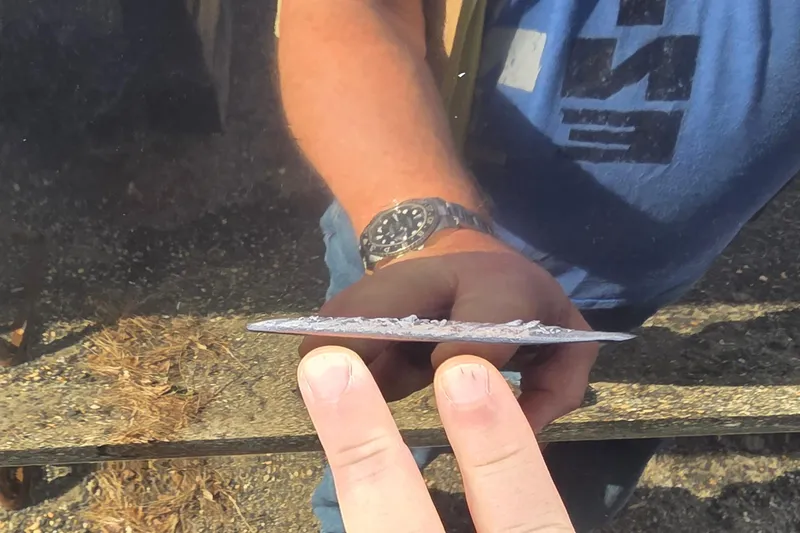 Slide: The Image of Man holding a corroded metal piece from a 2007 Sea Ray SLX 250 boat. - 24