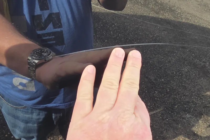 Slide: The Image of Hands inspecting a Sea Ray SLX 250 boat windshield, 2007 model. - 28