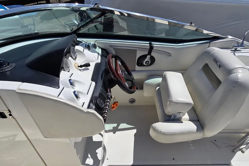 Slide: The Image of 2007 Sea Ray SLX 250 boat cockpit with steering wheel and white seating. - 3