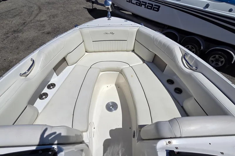 Slide: The Image of Bow seating area of a 2007 Sea Ray SLX 250 boat with white upholstery. - 4