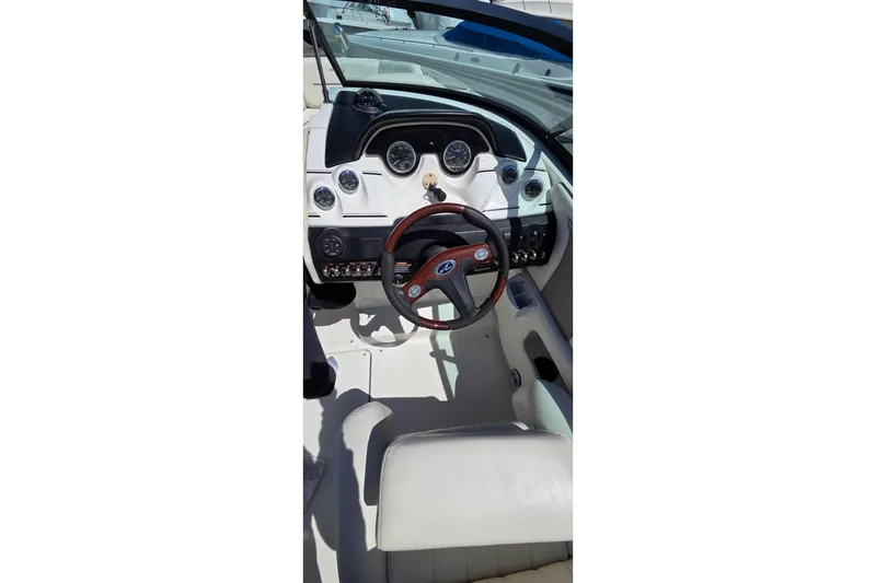 Slide: The Image of 2007 Sea Ray SLX 250 boat cockpit with steering wheel and dashboard controls. - 7