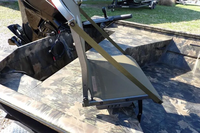 Slide: The Image of 2026 Crestliner 1860 Retriever Deluxe boat with camouflage interior and motor. - 12