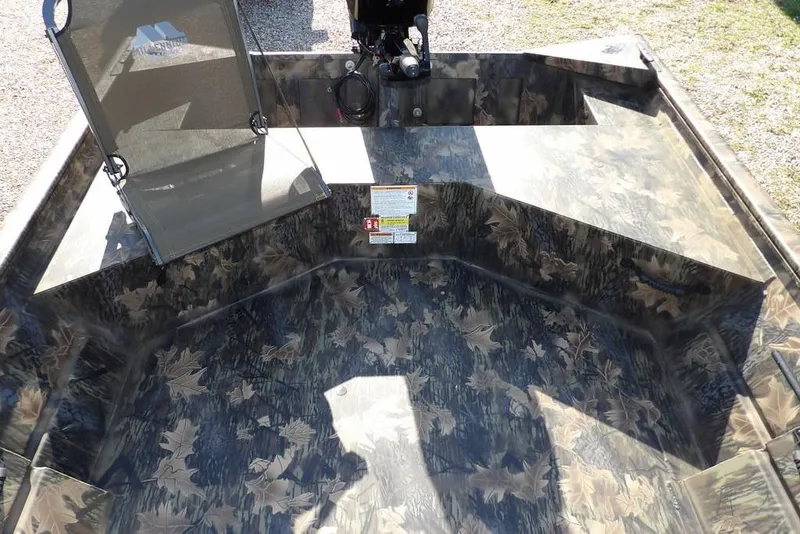 Slide: The Image of 2026 Crestliner 1860 Retriever Deluxe boat interior with camouflage design and seating. - 13