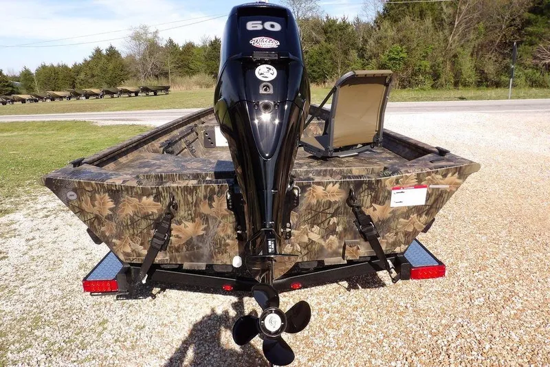 Slide: The Image of 2026 Crestliner 1860 Retriever Deluxe boat with camouflage design and powerful outboard motor. - 15